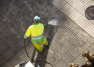 worker cleaning a street sidewalk with high pressu 2026 01 08 02 37 37 utc